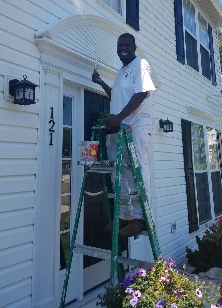 picture of man painting exterior