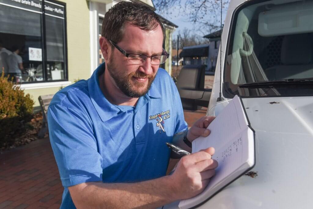 Klappenberger & Son Painting Franchisee giving an estimate at his truck